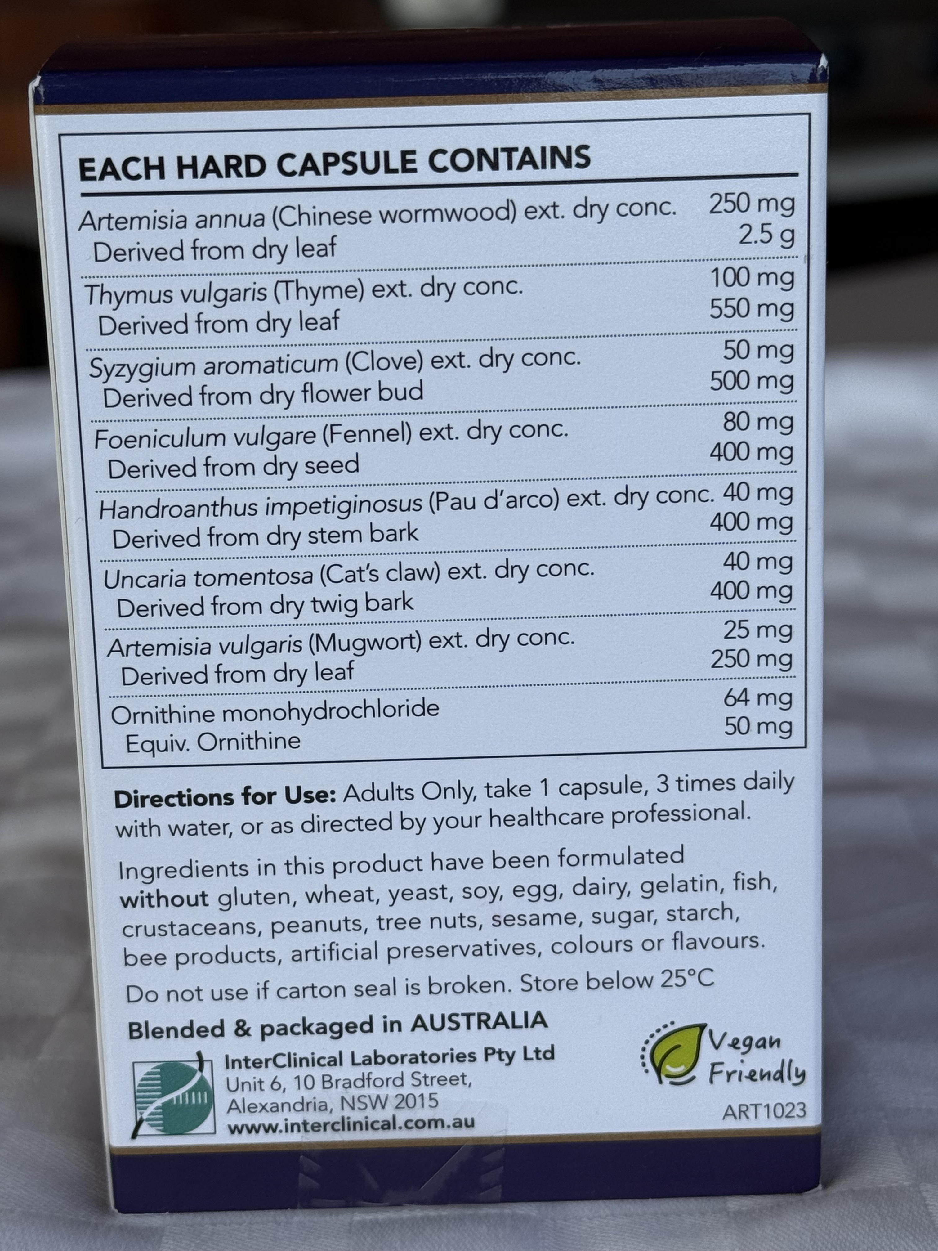 Box of herbal capsules with ingredient list and directions on a gray surface