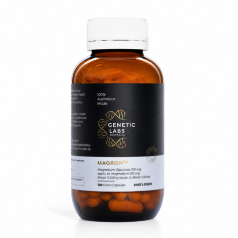 A bottle of Genetic Labs Magnon dietary supplement capsules, featuring an amber brown bottle, white cap, and a black label with gold and white text.
